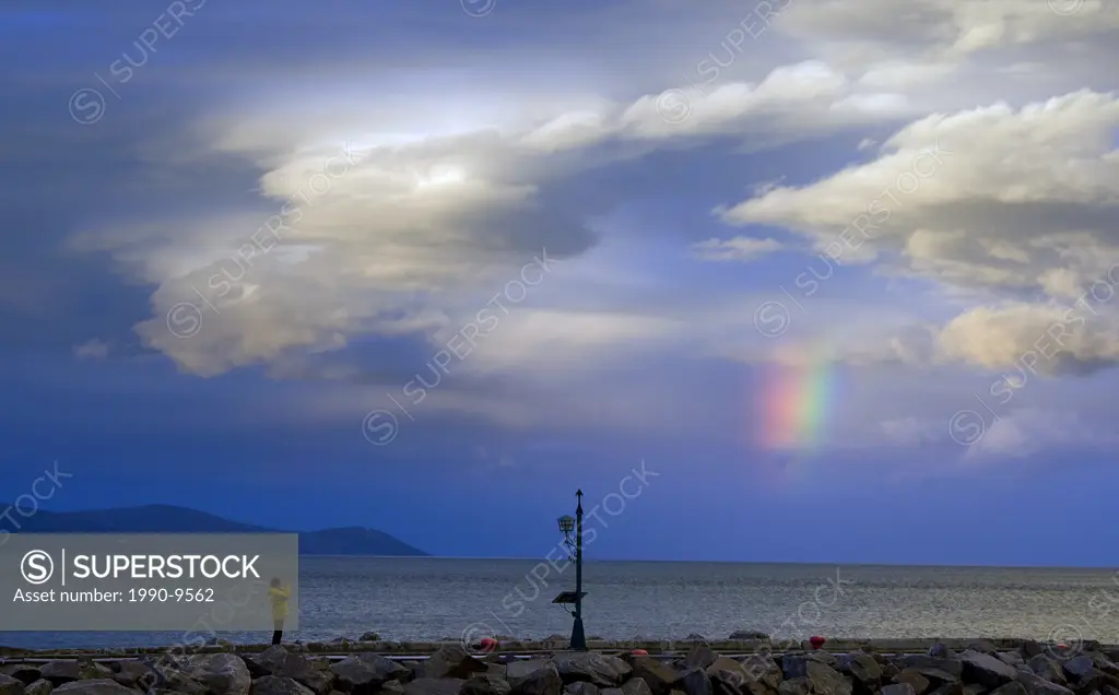 Person taking photograph of a rainbow, Saint_Ir©n©e, Quebec, Canada.