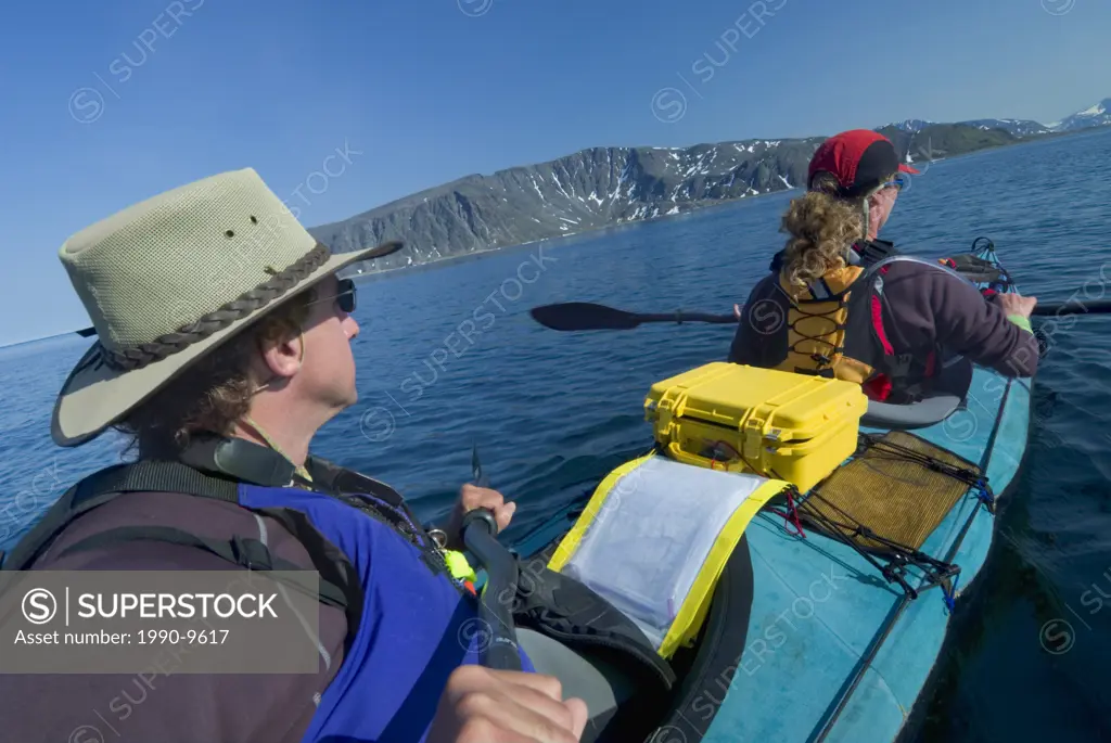 Kayaking in Ramah Bay with Torngat Mountains in the distance, Labrador, Newfoundland and Labrador, Canada.