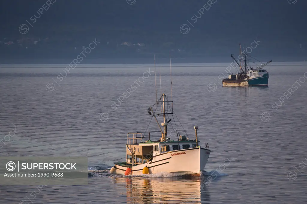 Fishing boats return to port in Annapolis Basin, Digby, Nova Scotia, Canada.