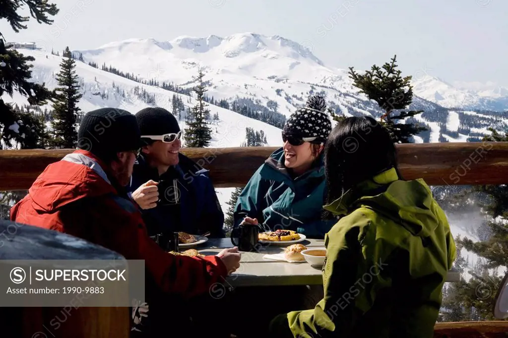 a group of skiers relaxing between runs, Whistler, British Columbia, Canada.