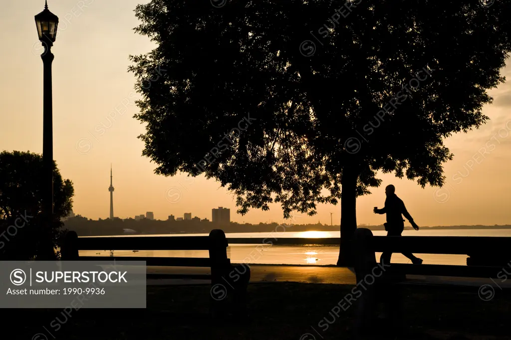 Hiker out for morning stroll along boardwalk at Toronto´s waterfront, Toronto, Ontario, Canada.