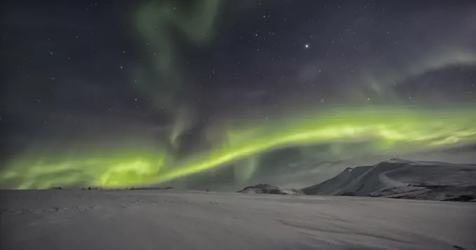 Northern lights or aurora borealis above the snow covered tundra along the Dempster Highway, Yukon.