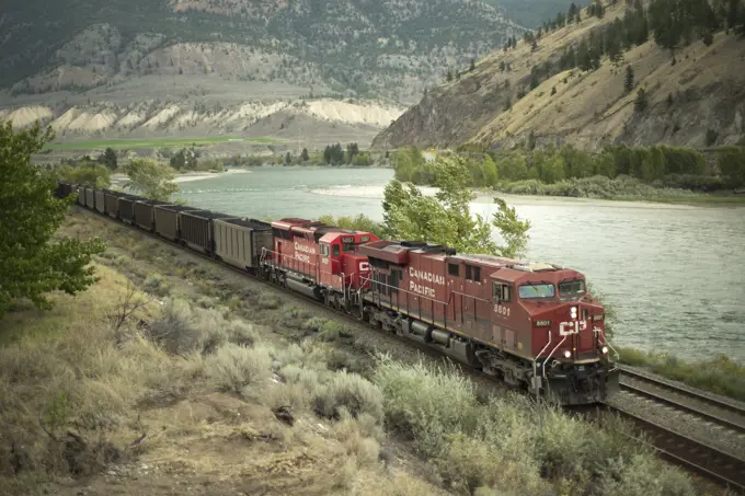 A CP (Canadian Pacific) coal train skirts along the Thompson River, through Spences Bridge, British Columbia, Canada. The coal is destined for the Por...
