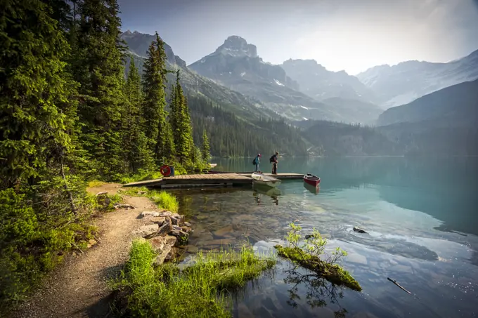 A couple on a dock at Lake O'Hara in Yoho National Park in the Canadian Rockies