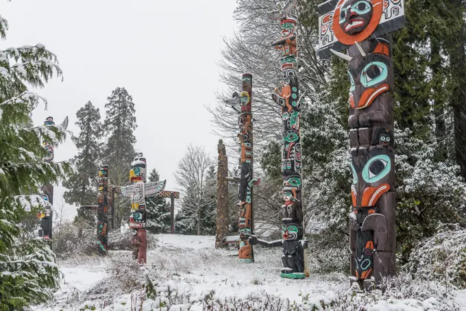 West coast totem poles with dusting of Winter snow, Brockton Point, Stanley Park, Vancouver, British Columbia, Canada