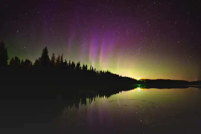 Norhern lights (Aurora borealis) reflected in Lac Sauvage Chibougameau Quebec Canada