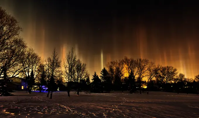 Light pillars originating from artificial light sources. Southdale Neighbourhood, Winnipeg, Manitoba, Canada