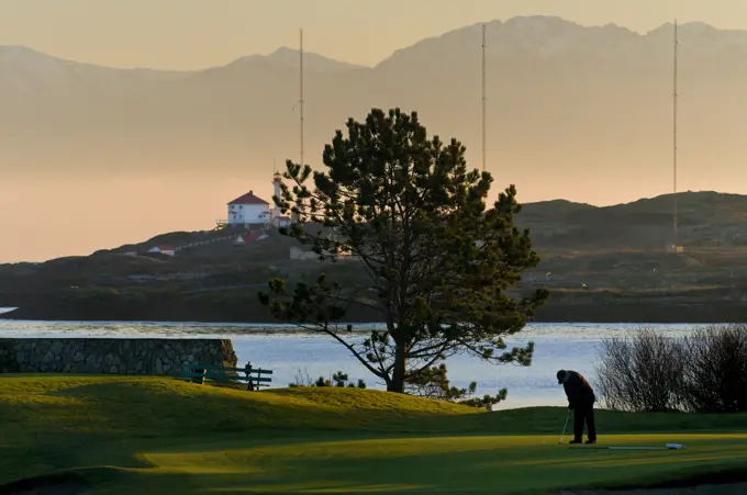 The Olympic Mountains and the Trial Island Light provide a dramatic backdrop for the Victoria Golf Club in Victoria BC.