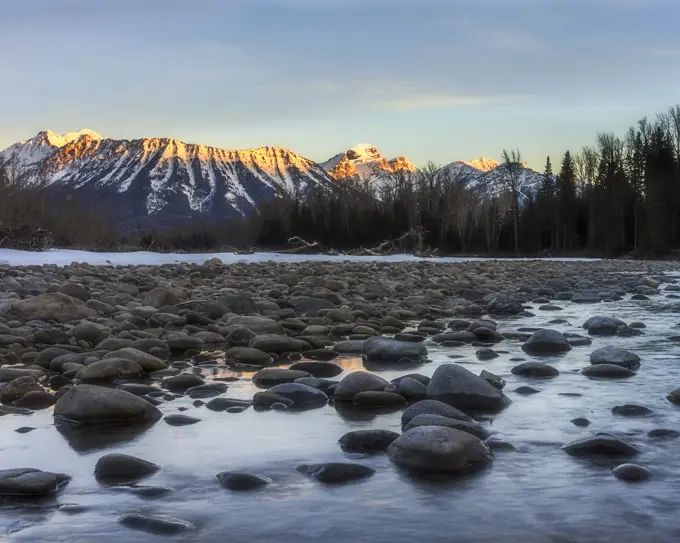 a winter sunrise on the Elk River looking towards Mount Fernie and the Three Sisters, Fernie, BC, Canada