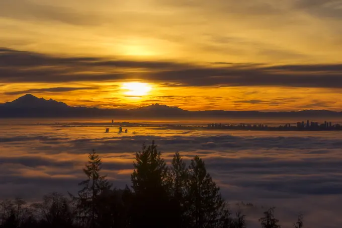 Sunrise over a cloud inversion from Cypress Provincial Park, Vancouver, British Columbia, Canada