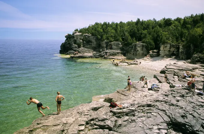 Swimmers enjoy the cool blue waters of Georgian Bay at Indian Head Cove, Bruce Peninsula National Park, Ontario, Canada