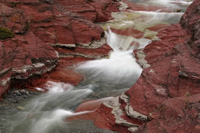 Red Rock Creek flowing through the eroded argillite sediments of Red Rock Canyon, Waterton Lakes National Park, Alberta, Canada