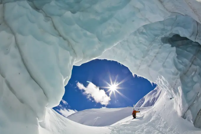 A backcountry skier touring up a heavily crevassed glacier at Icefall Lodge, Canadian Rockies, Golden, BC