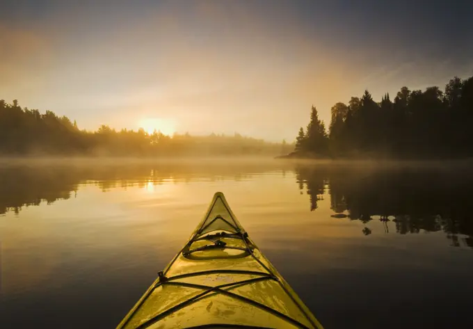 Kayaking during a mistly morning on Lake of the Woods, Northwestern Ontario, Canada