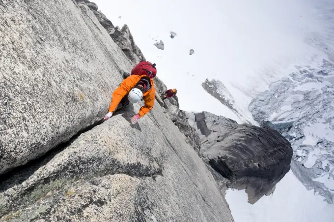 A pair of rock climbers ascend Surf's Up, a route on Snowpatch Spire in the Bugaboos, British Columbia