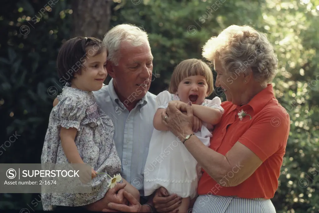 Grandparents with their granddaughters in a park