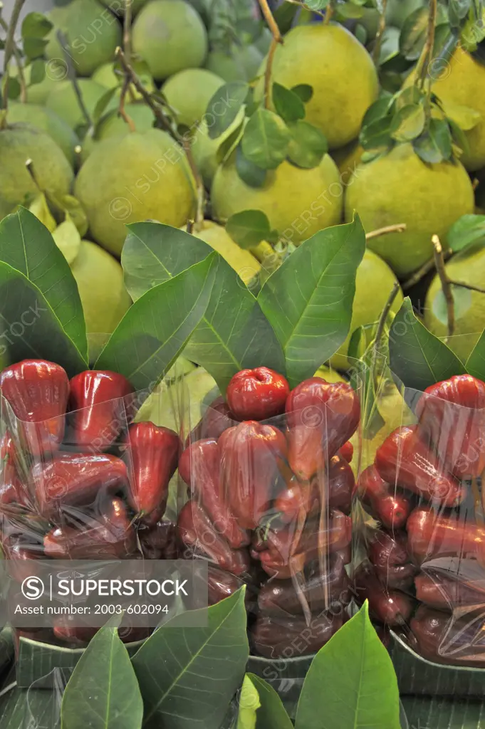 Apples and grapefruits for sale at a market stall, Bangkok, Thailand
