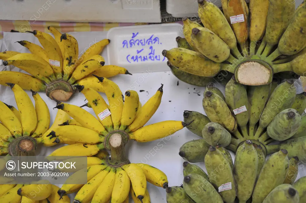 Lady finger bananas with green drier bananas at a market stall, Bangkok, Thailand