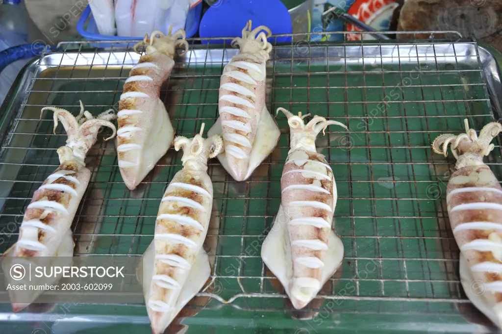 Grilled squid at a market stall, Bangkok, Thailand
