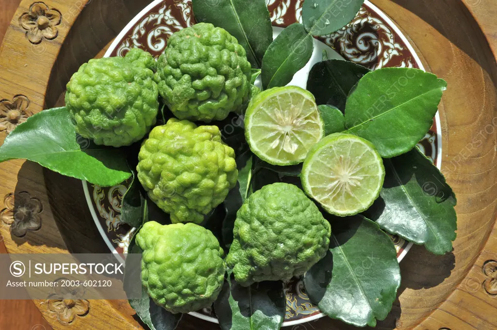 Close-up of Kaffir limes (Citrus hystix) on a plate, Thailand