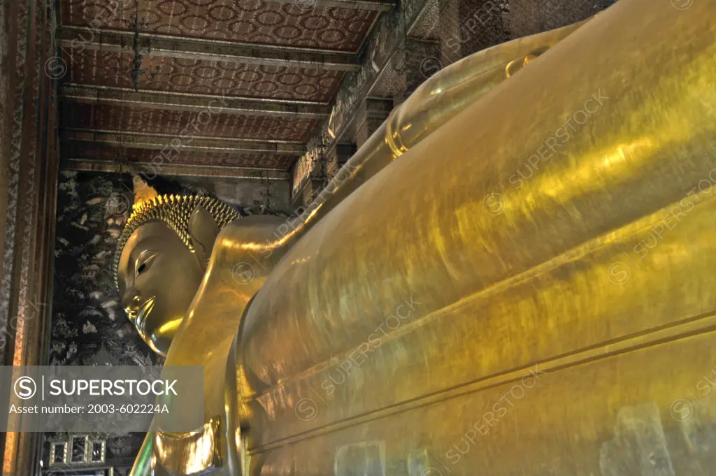 Golden statue of reclining Buddha in a temple, Wat Pho, Phra Nakhon District, Bangkok, Thailand