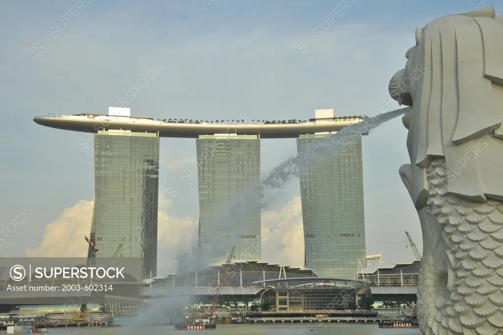 Merlion statue in a park with hotels in the background, Marina Bay Sands, Merlion Park, Marina Bay, Singapore City, Singapore
