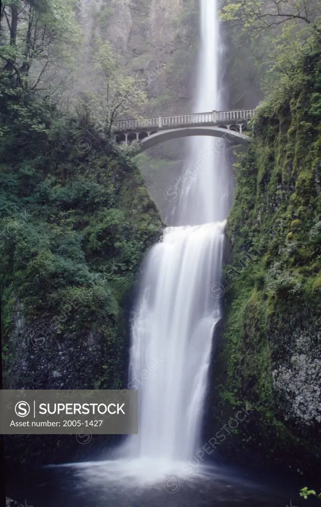 Low angle view of a bridge in front of a waterfall, Benson Bridge, Multnomah Falls, Columbia River Gorge National Scenic Area, Oregon, USA