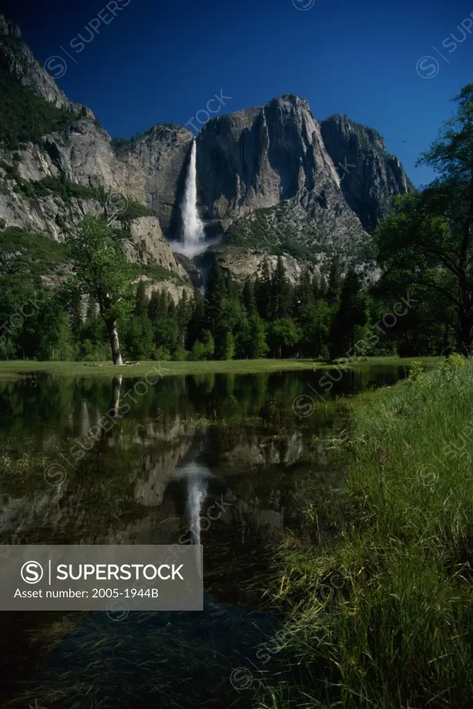 Reflection of a waterfall in a lake, Upper Yosemite Falls, Yosemite National Park, California, USA