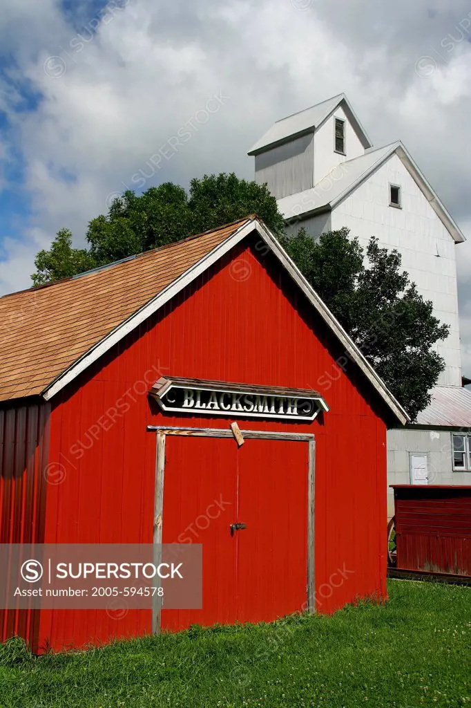 Old grain elevator and blacksmith shop in a field, Minnesota, USA