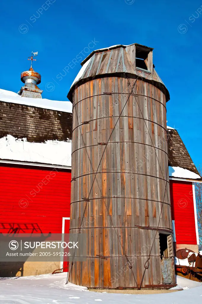 USA, Minnesota, Red Barn and Wooden Silo in Winter