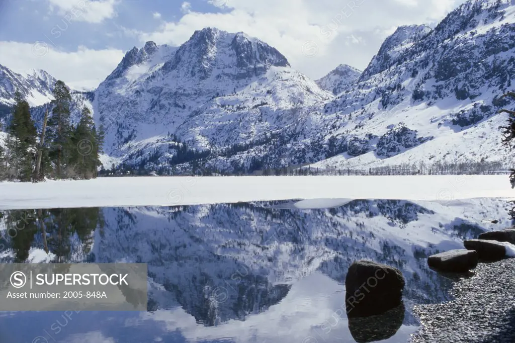 Reflection of snow covered mountains in water, Carson Peak, Californian Sierra Nevada, California, USA