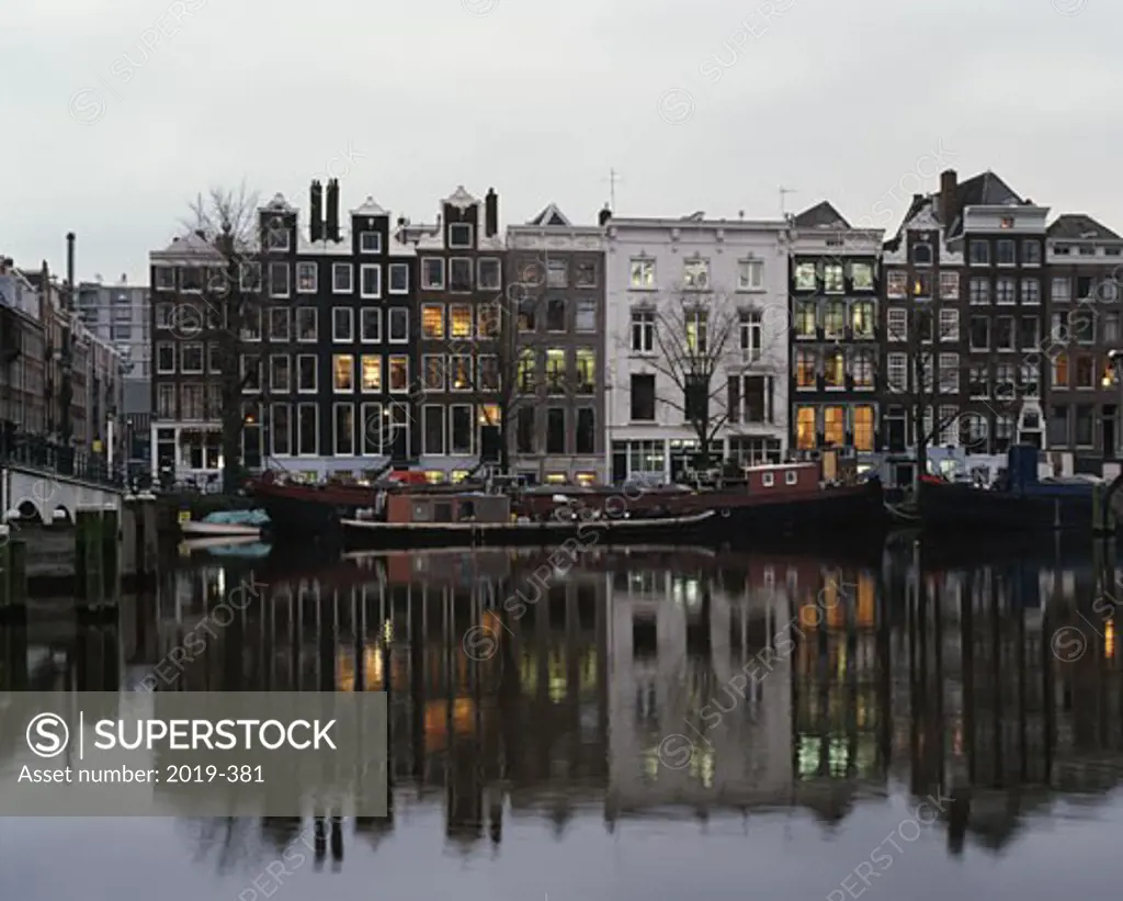 Netherlands, Amsterdam, building reflecting in canal