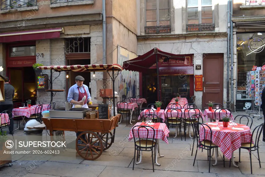 Empty tables and chairs at a sidewalk cafe, Lyon, Rhone-Alpes, France
