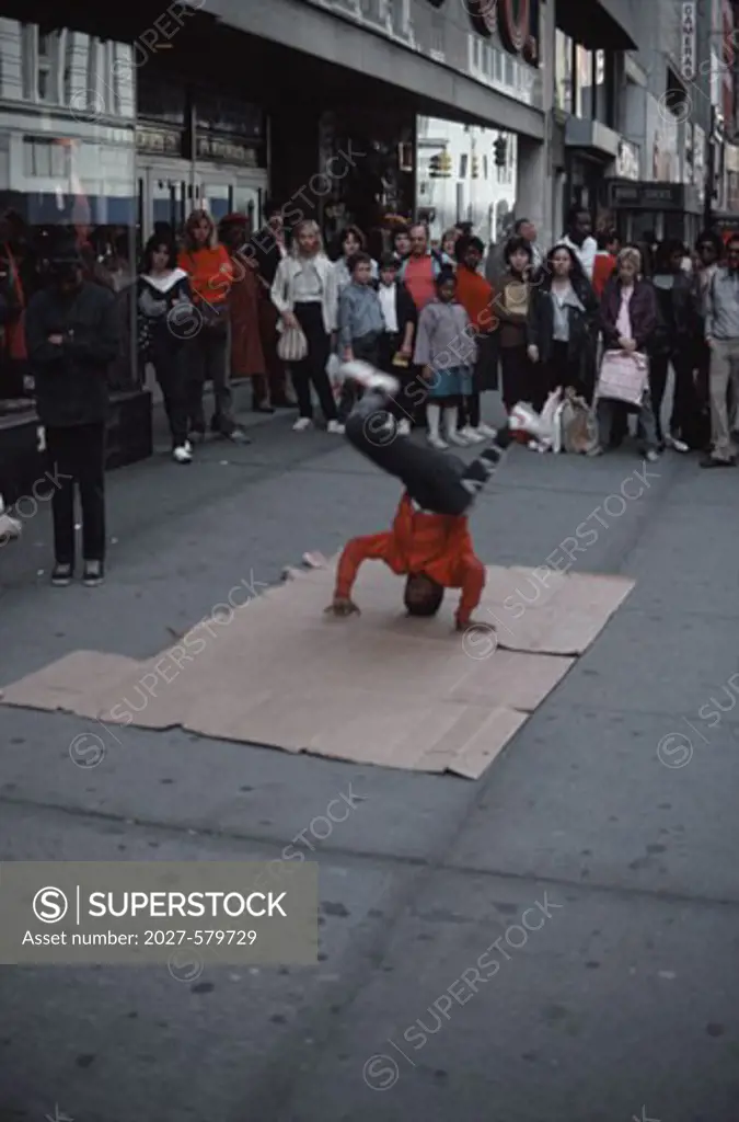 Boy breakdancing on a sidewalk, New York City, New York, USA