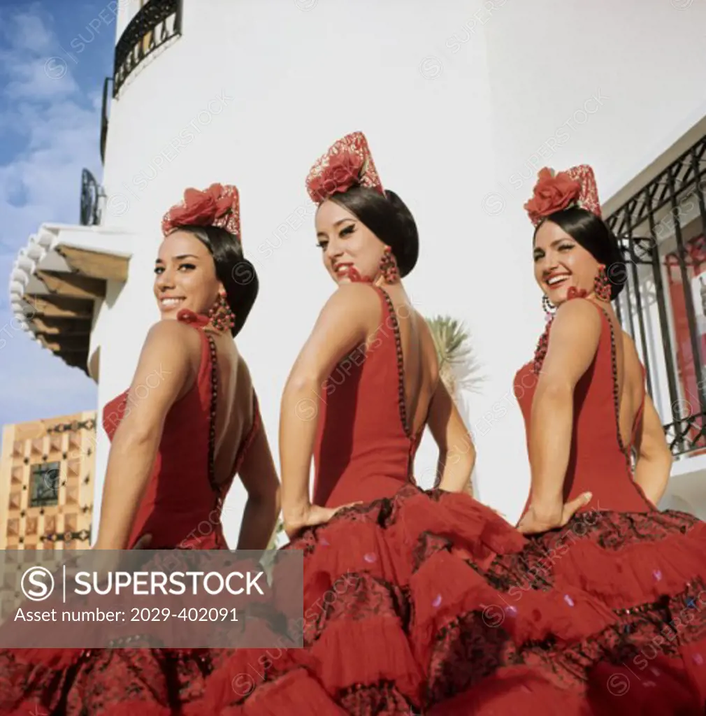 Side profile of three flamenco dancers posing, Spain