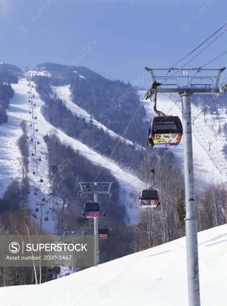 Ski lift over a snow covered landscape, Killington, Vermont, USA