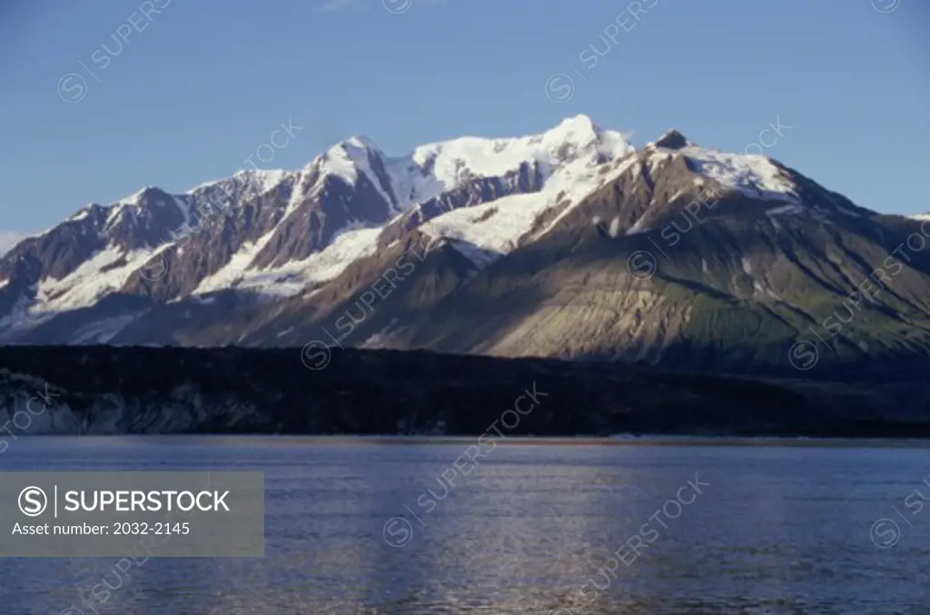 Lake in front of snowcapped mountains, Russell Fjord, Alaska, USA