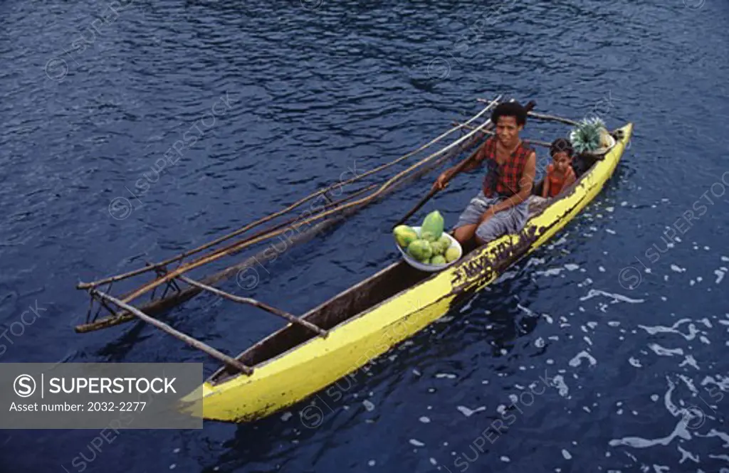 High angle view of a woman with her daughter in a boat, Milne Bay, Papua New Guinea
