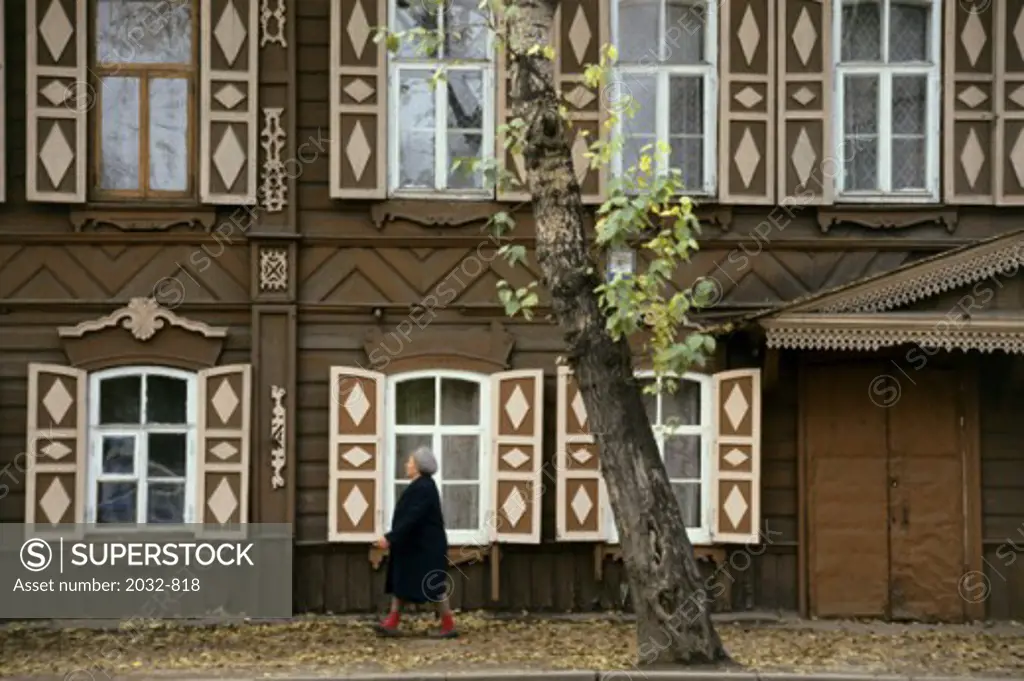 Woman walking in front of a building, Irkutsk, Russia