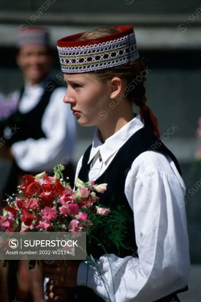 Side profile of a girl holding a bouquet of flowers, Riga, Latvia