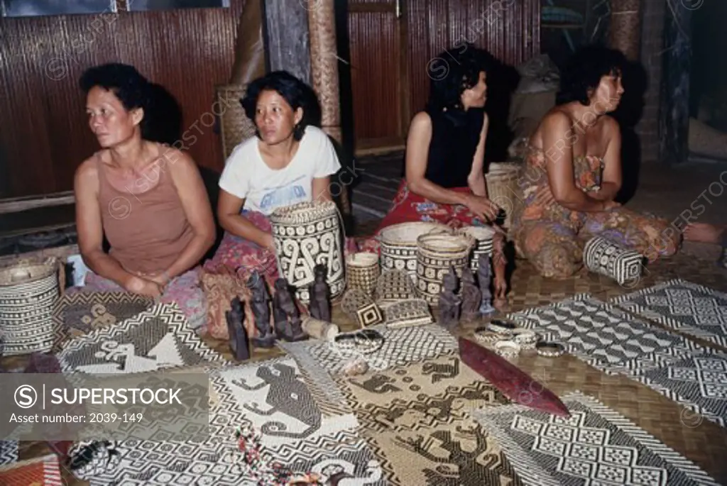 High angle view of four Iban women making craft products, Sarawak State, Malaysia