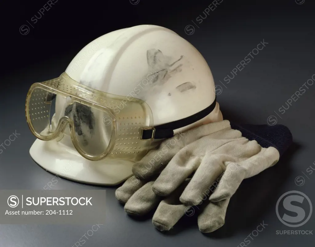 Close-up of a hard hat and protective gloves