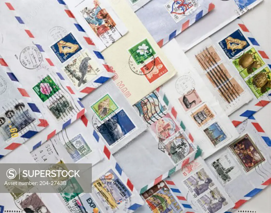 Close-up of postage stamps on envelopes