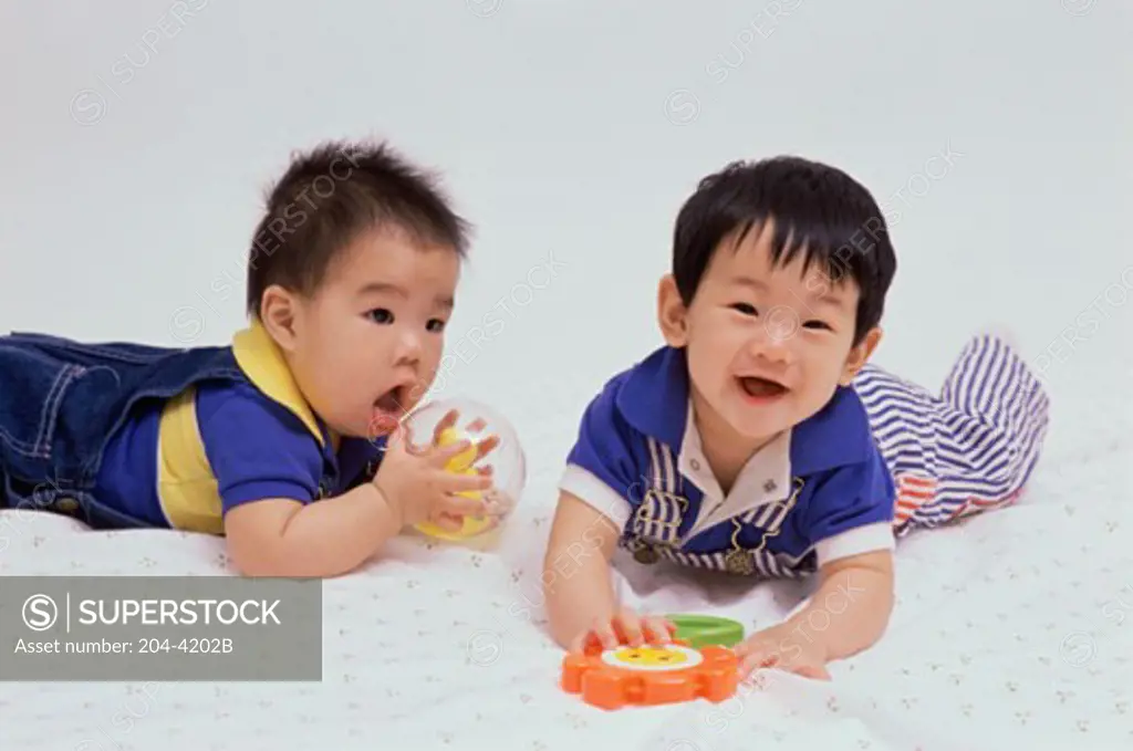Two baby boys playing