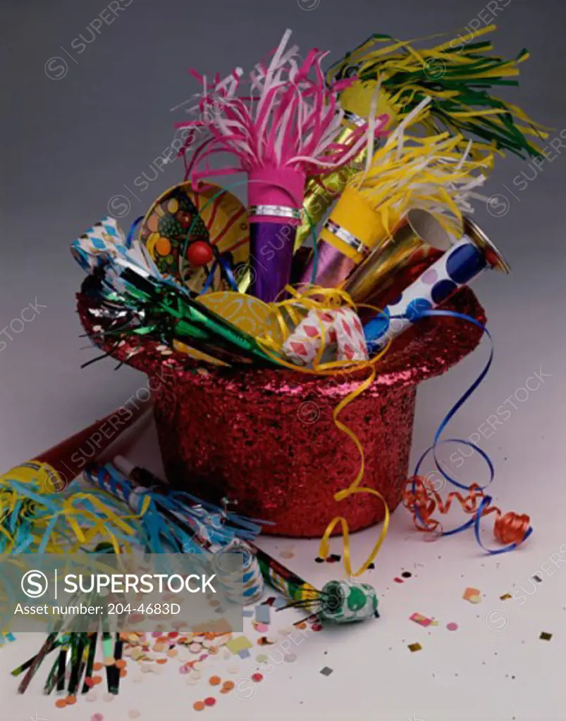 Noisemakers and confetti with a party hat