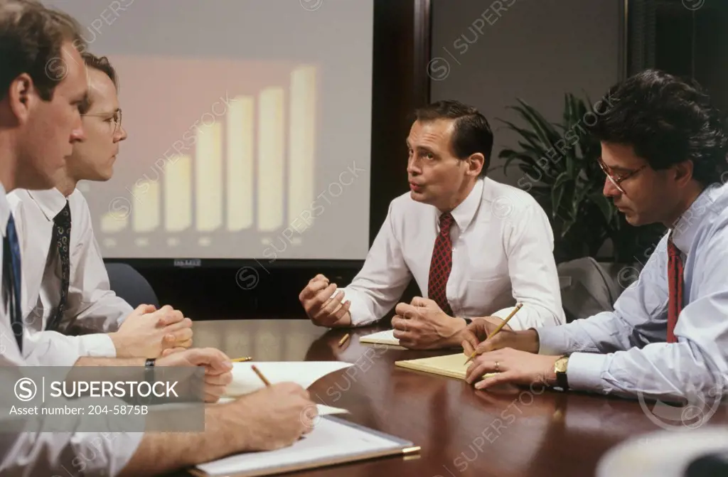 Four businessmen sitting in a meeting