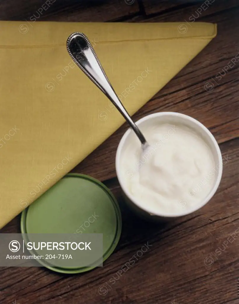 Close-up of yogurt in a container with a spoon