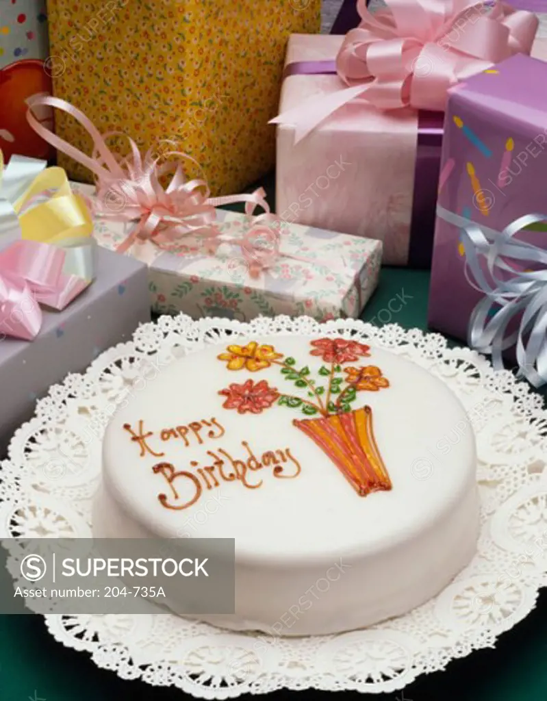 High angle view of a birthday cake with gifts