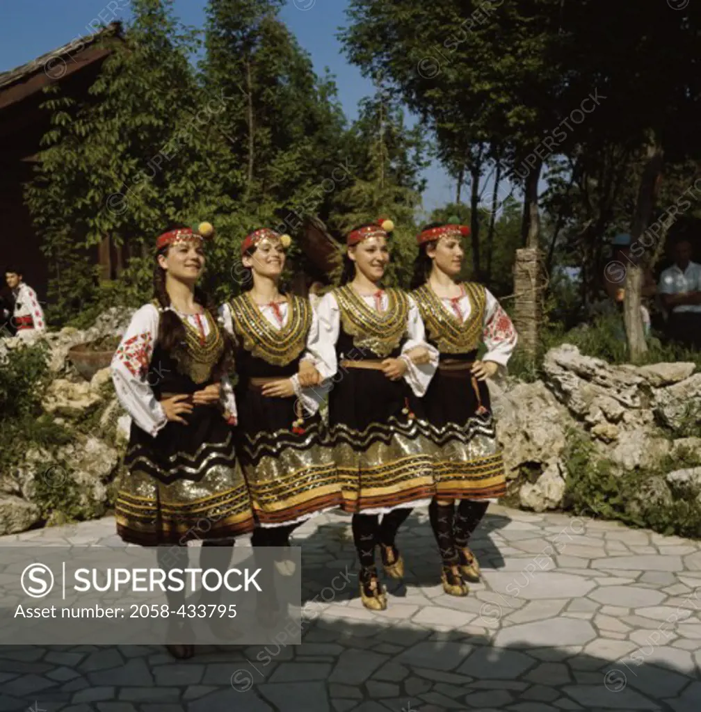 Women dancing wearing traditional costume of Bulgaria