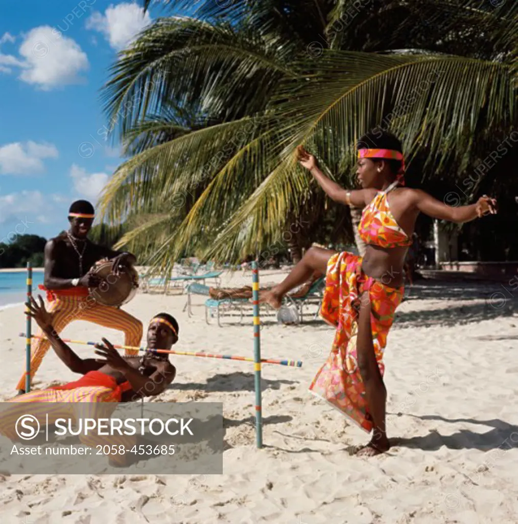 Three young men dancing on the beach, Limbo Dance, Barbados